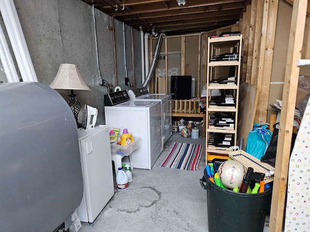 basement with independent washer and dryer and white fridge