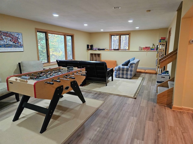 rec room with light hardwood / wood-style flooring