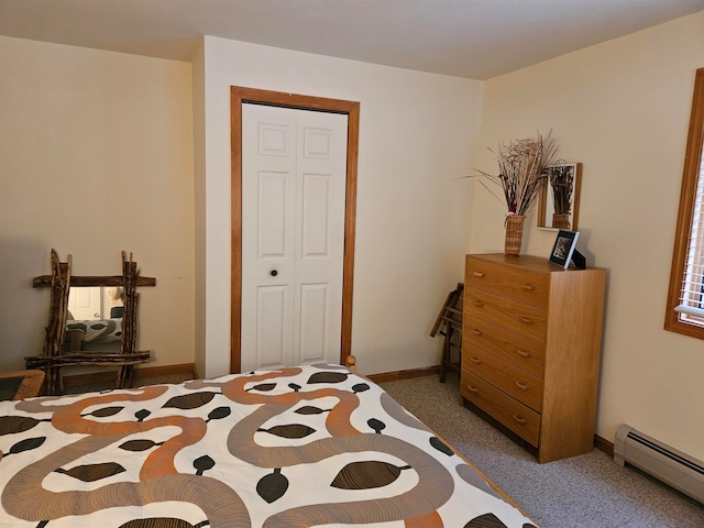 bedroom with a closet, carpet flooring, and a baseboard radiator