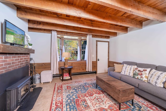 living room featuring beam ceiling, a wood stove, light tile patterned floors, and wooden ceiling