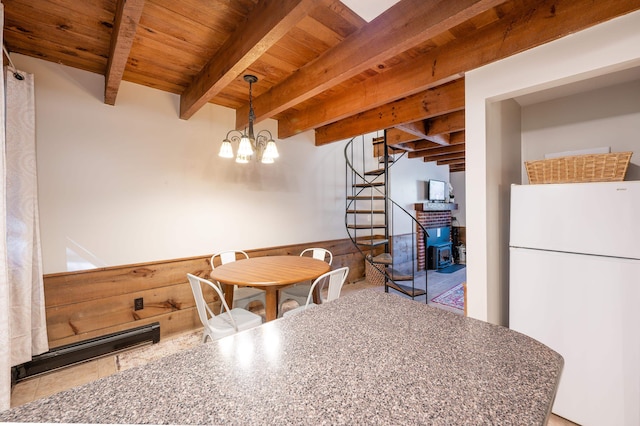 tiled dining area with a notable chandelier, wooden ceiling, and beamed ceiling