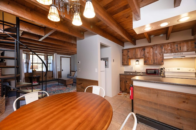 tiled dining room featuring beamed ceiling and wooden ceiling