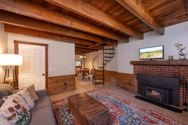 living room with beamed ceiling, a brick fireplace, light tile patterned floors, and wood ceiling