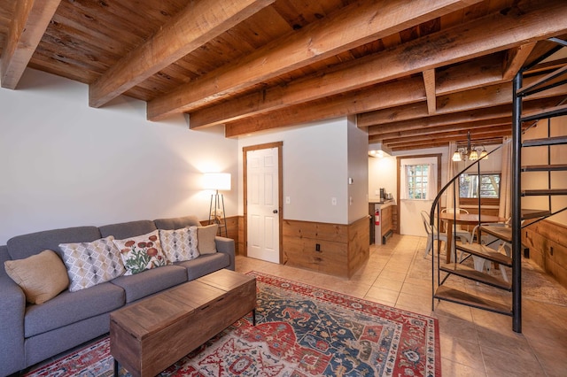 tiled living room with beam ceiling, a notable chandelier, and wood ceiling