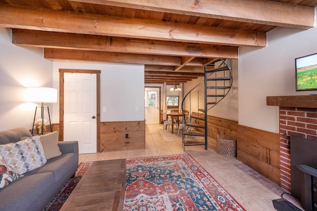 living room with beam ceiling, light tile patterned flooring, and wood ceiling