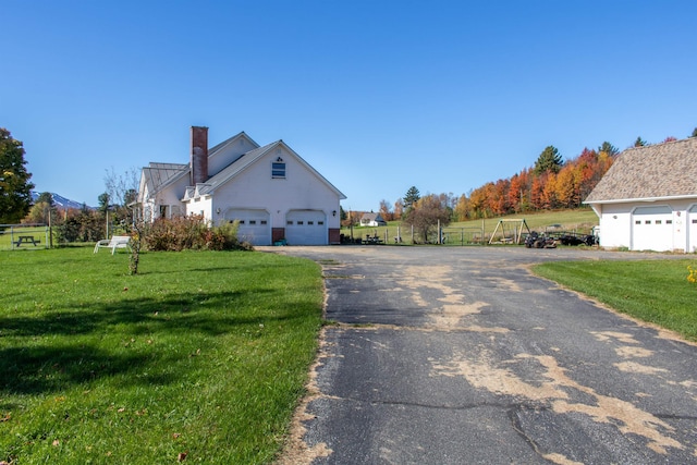 view of side of home featuring a yard and a garage