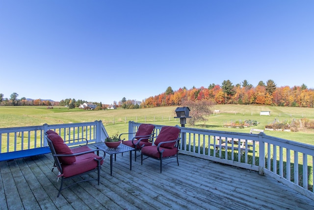 deck featuring a yard and a rural view