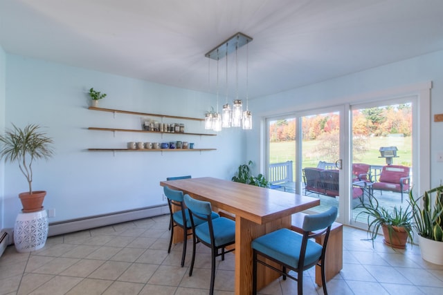 dining space with a baseboard heating unit and light tile patterned flooring