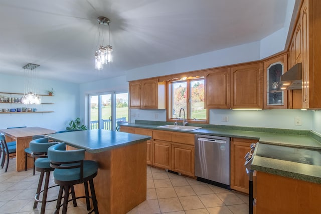 kitchen featuring sink, a center island, hanging light fixtures, stainless steel dishwasher, and range hood