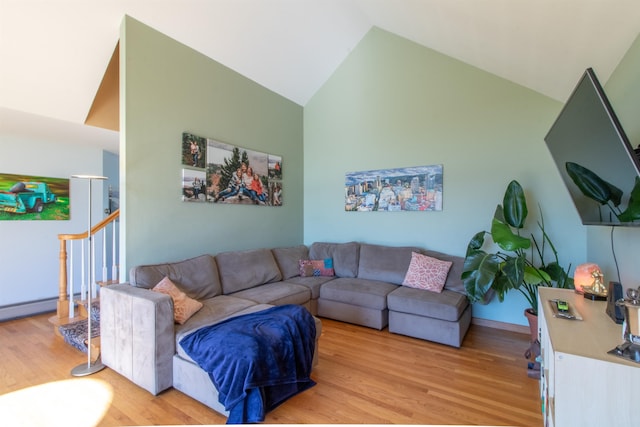 living room featuring high vaulted ceiling and light wood-type flooring