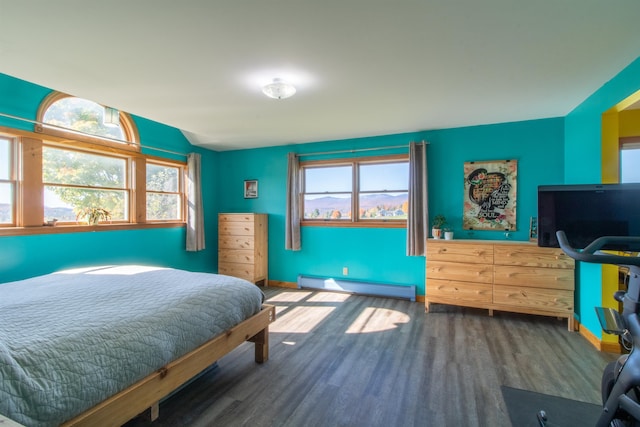 bedroom with dark wood-type flooring and baseboard heating