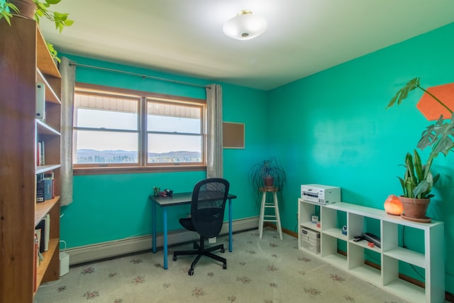 office featuring a mountain view and light colored carpet