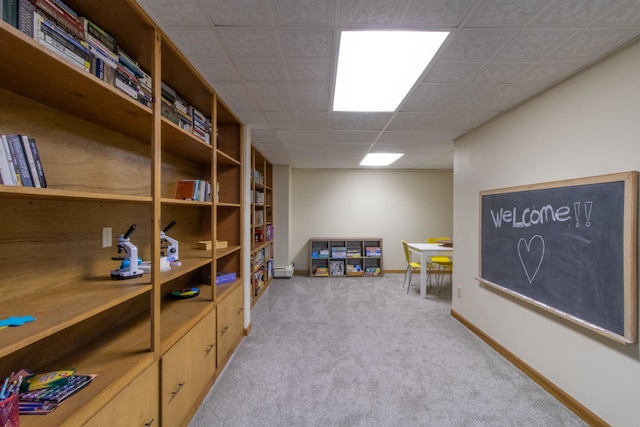 game room featuring baseboard heating and light colored carpet