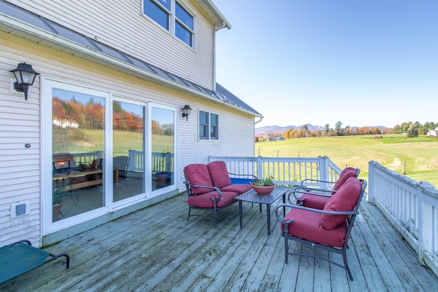 wooden deck featuring a lawn