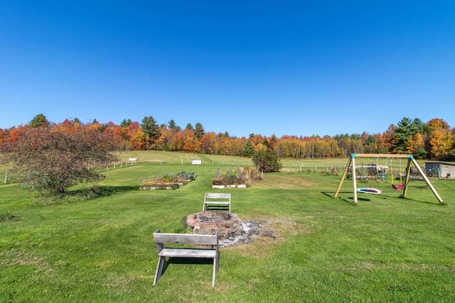 view of yard with a playground and a rural view