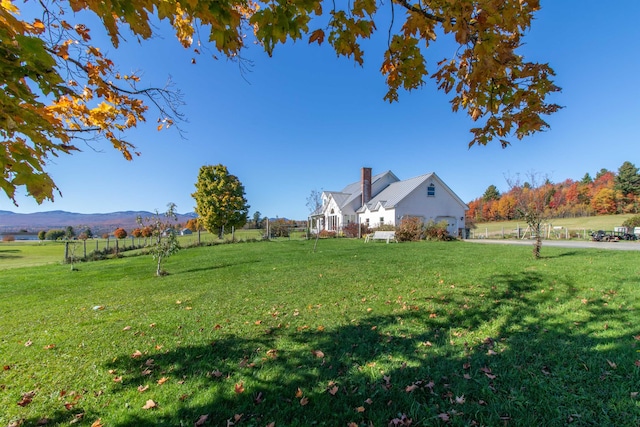 view of yard featuring a mountain view and a rural view