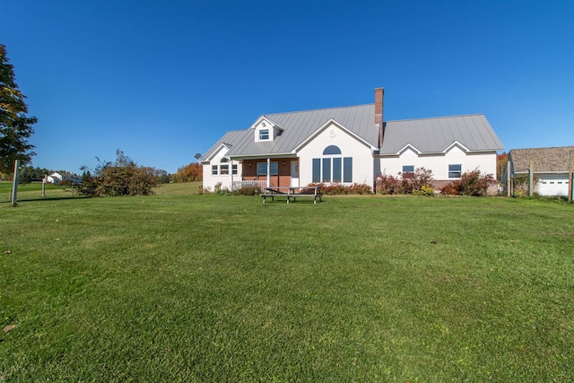 rear view of property featuring a yard