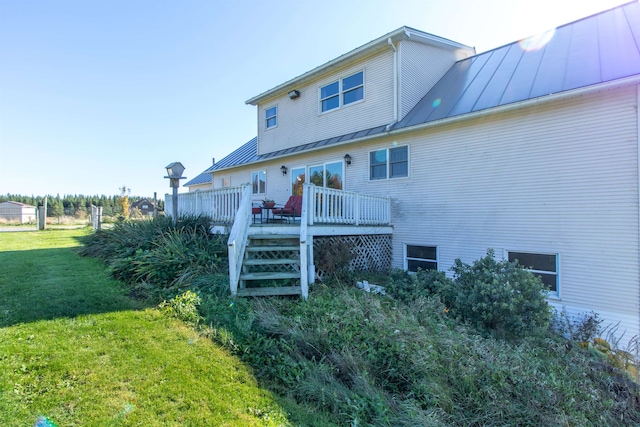 back of house with a yard and a deck