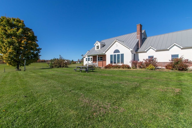 rear view of property featuring a yard