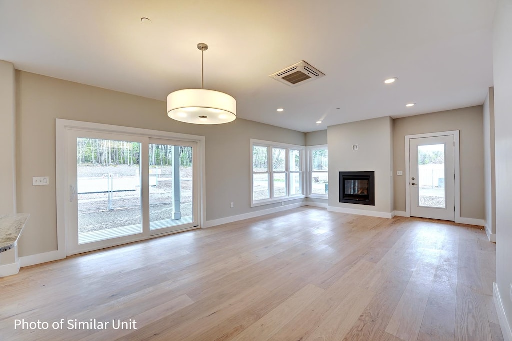 unfurnished living room with light hardwood / wood-style flooring