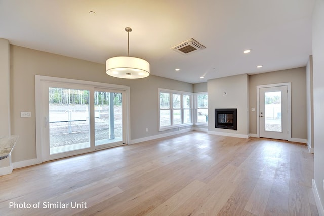 unfurnished living room with light hardwood / wood-style flooring