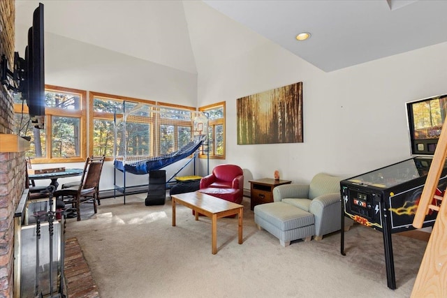 living area with carpet floors and high vaulted ceiling