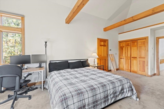 carpeted bedroom with beamed ceiling, high vaulted ceiling, and a closet