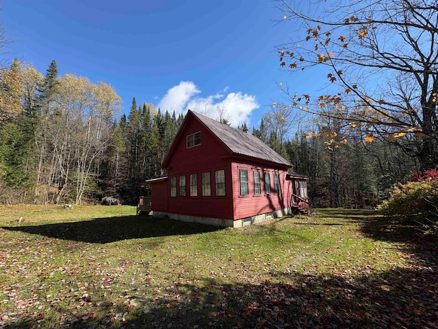 view of side of home with a yard