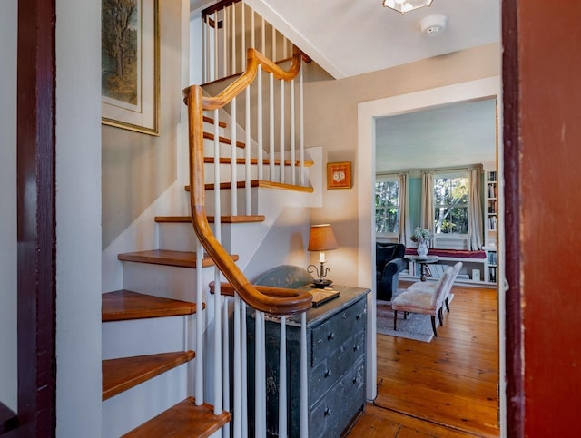 staircase with hardwood / wood-style flooring