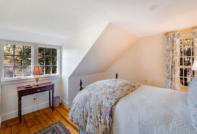 bedroom featuring vaulted ceiling and hardwood / wood-style floors