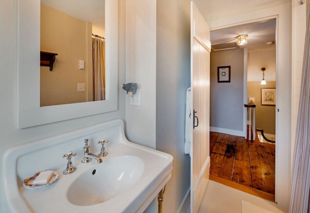 bathroom featuring wood-type flooring and sink