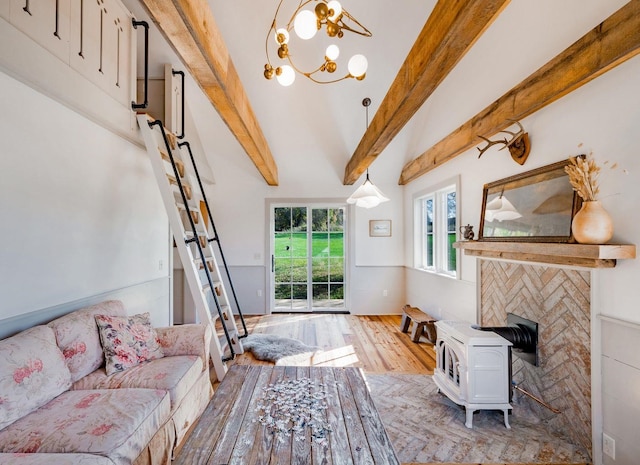 living room featuring hardwood / wood-style flooring, beamed ceiling, and a chandelier