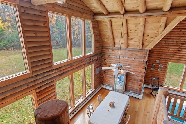 sunroom / solarium with a baseboard radiator, ceiling fan, vaulted ceiling with beams, and wooden ceiling