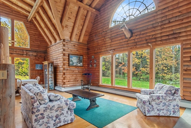 unfurnished living room with beamed ceiling, light hardwood / wood-style flooring, a baseboard heating unit, and high vaulted ceiling