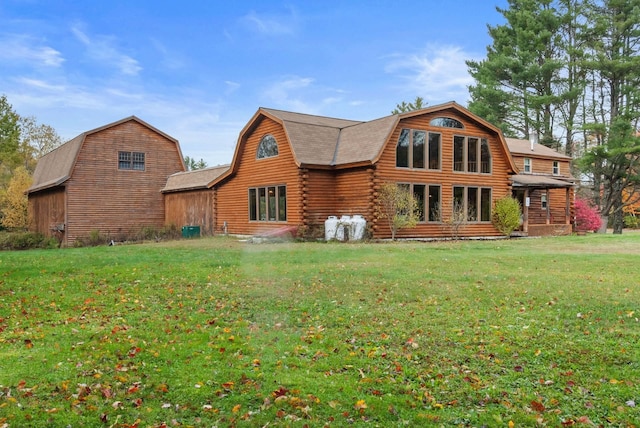 back of house with log siding, a lawn, and a gambrel roof