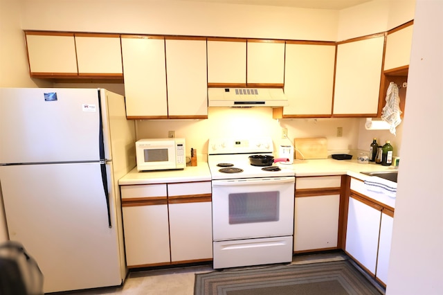 kitchen with cream cabinetry and white appliances