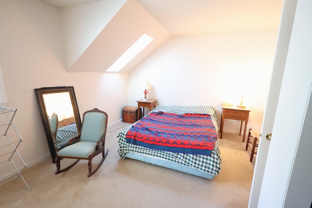 bedroom with lofted ceiling with skylight and carpet flooring