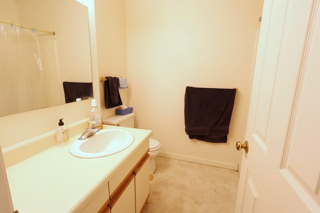 bathroom featuring vanity, toilet, and walk in shower