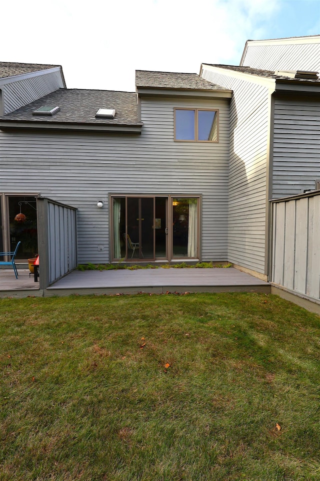 rear view of property featuring a patio and a yard