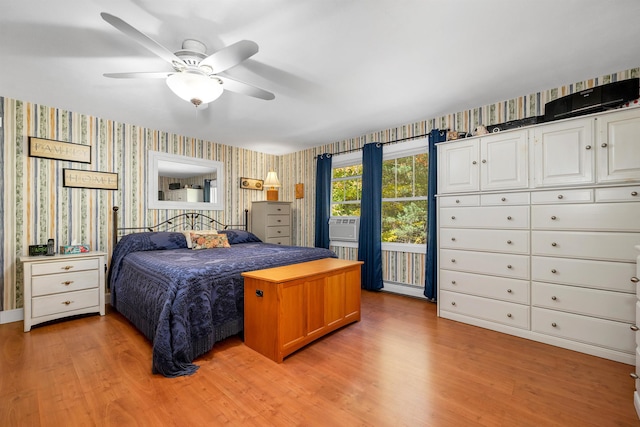 bedroom with light hardwood / wood-style floors, ceiling fan, and cooling unit