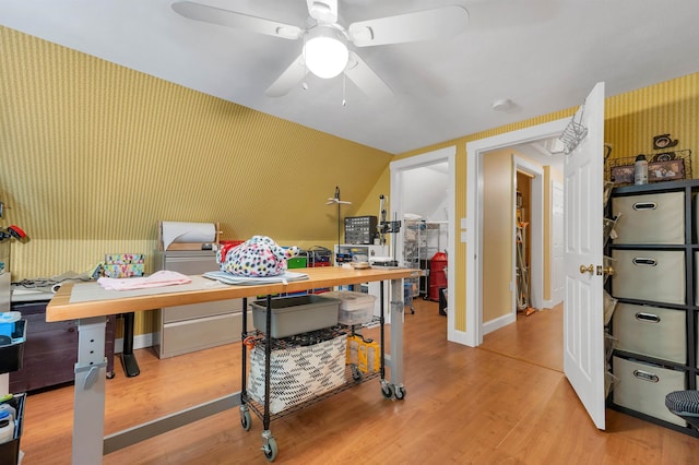 home office with hardwood / wood-style flooring, vaulted ceiling, and ceiling fan