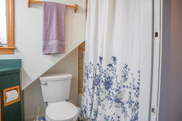 bathroom with toilet and shower / bath combo with shower curtain