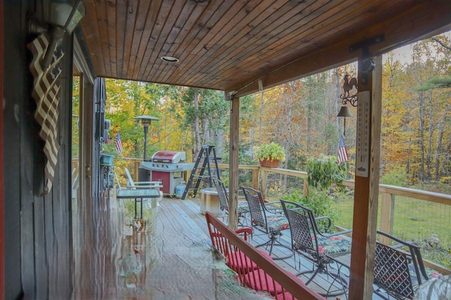 wooden terrace featuring a grill