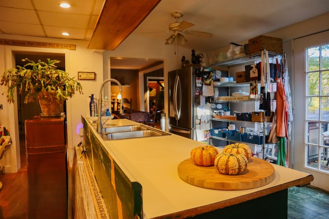 interior space featuring sink, a drop ceiling, and ceiling fan