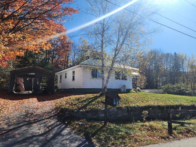 view of side of home with a carport