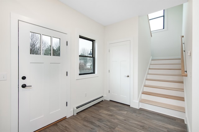 foyer with a baseboard heating unit and dark hardwood / wood-style flooring