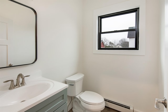 bathroom with vanity, toilet, and a baseboard heating unit