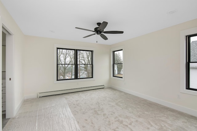 unfurnished bedroom with light carpet, baseboard heating, and ceiling fan