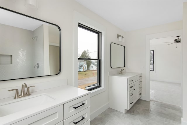 bathroom with vanity and a tile shower