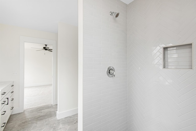 bathroom with vanity, tiled shower, and ceiling fan